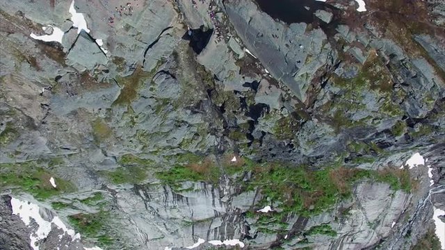 Aerial footage of the cliff with famous Trolltunga rock. Top-down aerial view. Aerial 4k Ultra HD.