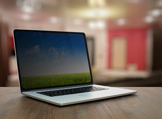 computer on wooden table in room