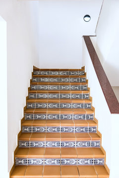 tile staircase with a handrail
