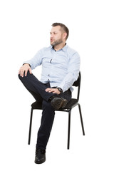 man sitting on chair. Isolated white background. Body language. gesture. Training managers. sales agents.  legs crossed, fixed arm. misses. dominant position