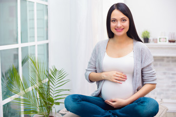 Young pregnant woman at home