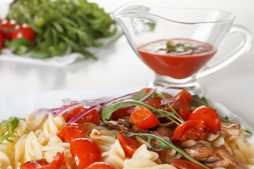 Pasta with mushrooms, cherry tomatoes and tomato sauce, italian food. Closeup