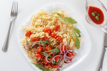 Pasta with mushrooms, cherry tomatoes and tomato sauce, italian food. Closeup