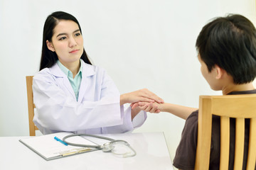 Hand of doctor reassuring her patient
