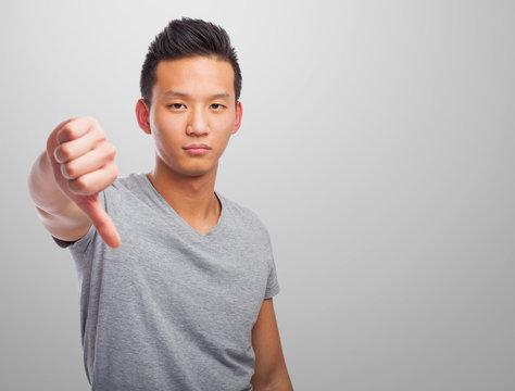 portrait of an asian man doing a negative gesture