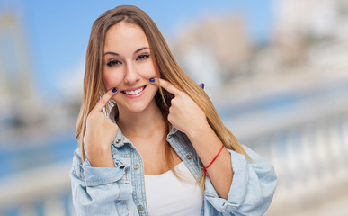 beautiful young girl making sign to smile