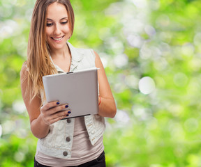 Fototapeta premium beautiful young woman using her white tablet