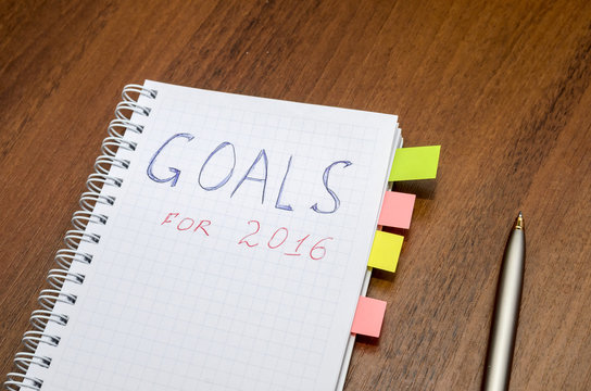 goals of year 2016 write on notebook on wooden background