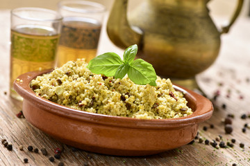 couscous with vegetables and tea on a rustic wooden table