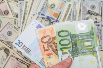 Euro bills above dollars background