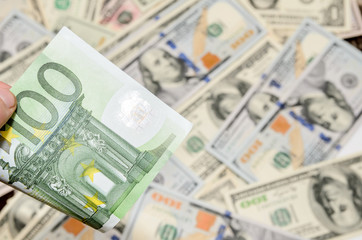 Euro bills above dollars background
