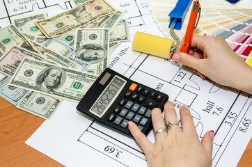 architectural plans with palette of colors, money, calculator, notepad