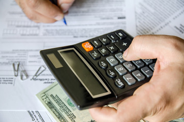 Cropped image of  Businessman calculating and checking tax