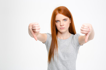 Sad disappointed woman showing thumbs down with both hands
