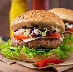 Sandwich hamburger with juicy burgers, cheese and mix of cabbage