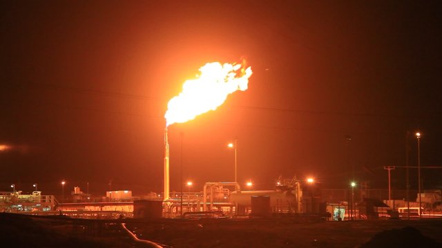 Burning gas flare in the desert. The petrochemical industry on natural gas and petrol production. Kingdom of Bahrain, Middle East
