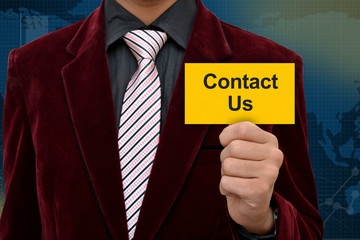 Professional holding contact us card in hand with suit