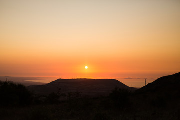 sunset silhouette with sea in background