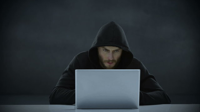 Composite video of hacker using laptop