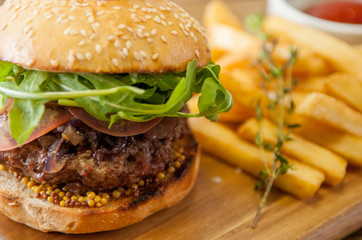 Home made burgers on wooden background