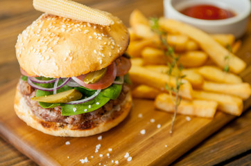 Home made burgers on wooden background