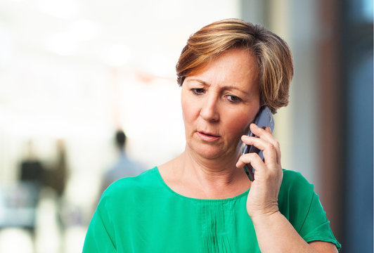 portrait of a worried mature woman talking on telephone