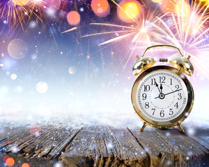 Midnight Celebration - Clock On Snowy Table With Fireworks
 - obrazy, fototapety, plakaty