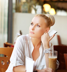 Middle-age woman sitting at an outdoor cafe 