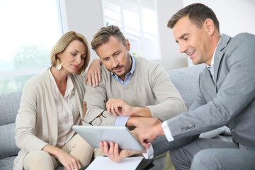 Financial adviser showing terms of contract on tablet