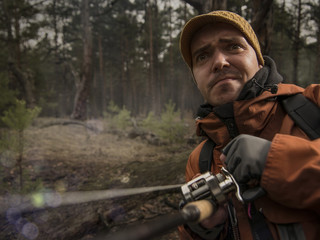 Mature man fishing  on the wild river