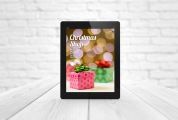 news tablet on wooden table christmas shopping