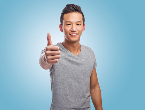 Portrait Of Young Asian Man With Thumb Up