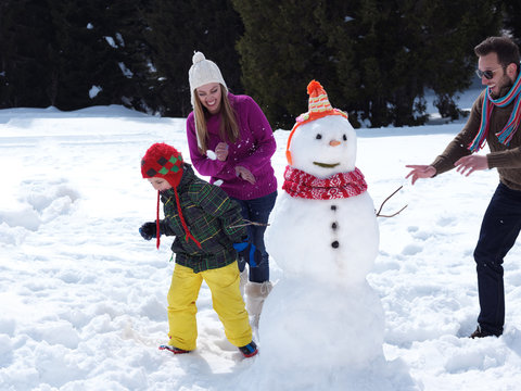 happy family making snowman