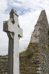 celtic cross and church ruins