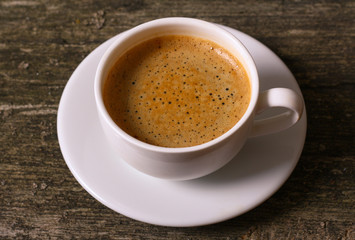 cup of coffee on the old wooden table