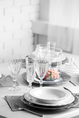 Table set at restaurant on light background