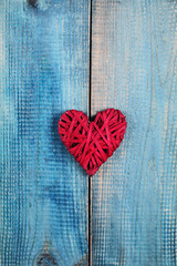 Love concept. Red heart over blue rustic wooden background wooden background. Valentine's Day  poster or postcard design. Vintage image