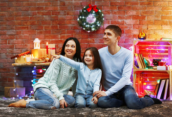 Happy family in the decorated Christmas room