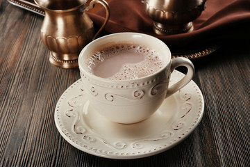 Vintage cup of cacao on wooden background