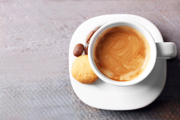 Cup of coffee on wooden table background