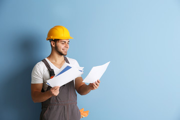Young worker renewing apartment on wall background