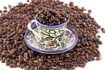 cup of coffee on coffee beans