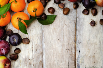 fruit. tangerines, plums, pumpkins, apples and chestnuts