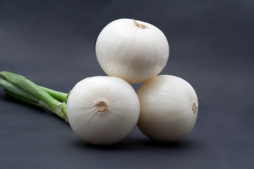 fresh white onions on a black  background