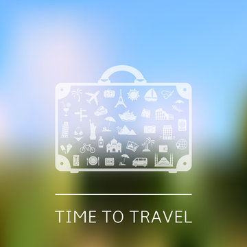Time to travel - suitcase with travel signs on blurred landscape background
