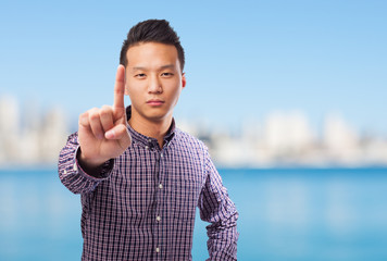 Fototapeta premium portrait of an asian man doing the one gesture