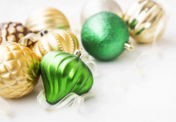 Green and golden Christmas ornaments with pearly globes and ribb