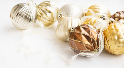 Fototapeta na wymiar Golden Christmas tree ornaments with delicate balls and ribbon