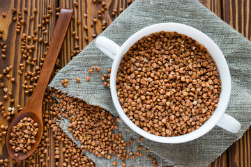 plate of buckwheat on a napkin next to the wooden spoon