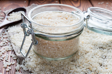 Bank of rice on wooden table closeup